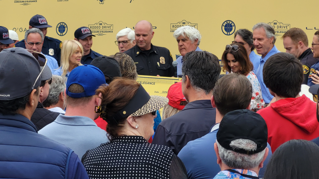 jay leno and lili bosse give checks to fire department beverly hills rodeo drive concours d'elegance